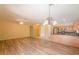 Bright living room with laminate flooring and access to kitchen at 45091 W Cypress Ln, Maricopa, AZ 85139