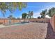 Relaxing backyard oasis featuring a sparkling pool and desert landscape at 45091 W Cypress Ln, Maricopa, AZ 85139