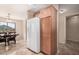 Kitchen with wood cabinets and a large refrigerator at 4572 E Silverbell Rd, San Tan Valley, AZ 85143