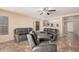 Living room with gray reclining sofas and a view into the kitchen at 4572 E Silverbell Rd, San Tan Valley, AZ 85143