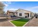 Backyard oasis featuring a pergola and artificial turf at 45762 W Dirk St, Maricopa, AZ 85139