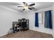 Bedroom with home office setup and ceiling fan at 45762 W Dirk St, Maricopa, AZ 85139