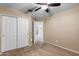 Bedroom with double door closet and ceiling fan at 45762 W Dirk St, Maricopa, AZ 85139