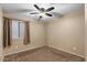 Spacious bedroom with ceiling fan and neutral decor at 45762 W Dirk St, Maricopa, AZ 85139