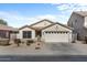 Single-story house with a two-car garage and desert landscaping at 45762 W Dirk St, Maricopa, AZ 85139