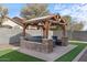 Pergola patio with built-in seating and fire pit at 45762 W Dirk St, Maricopa, AZ 85139