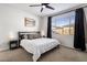 Main bedroom with a king-size bed and ceiling fan at 4816 S 117Th Ave, Avondale, AZ 85323