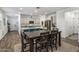 Open concept dining area with a large table and view into the kitchen and living room at 4816 S 117Th Ave, Avondale, AZ 85323