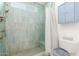 Clean bathroom with shower, toilet and built-in storage at 5210 W Ironwood Dr, Glendale, AZ 85302