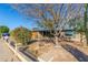 House exterior showcasing a brick facade, mature trees, and a well-maintained yard at 5210 W Ironwood Dr, Glendale, AZ 85302