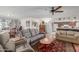 Spacious living room with gray sofas, a coffee table, and a view of the kitchen at 5210 W Ironwood Dr, Glendale, AZ 85302