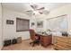 Home office with wood desk, chair, and large window at 5210 W Ironwood Dr, Glendale, AZ 85302