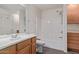 Bathroom with shower/tub combo and wood cabinets at 5239 Rayanna Ct, Phoenix, AZ 85015