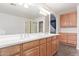 Double vanity bathroom with wood cabinets and a large mirror at 5239 Rayanna Ct, Phoenix, AZ 85015