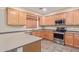 Modern kitchen featuring wood cabinets, granite countertops, and stainless steel appliances at 5239 Rayanna Ct, Phoenix, AZ 85015