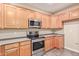 Modern kitchen with stainless steel appliances and light wood cabinets at 5239 Rayanna Ct, Phoenix, AZ 85015