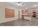 Kitchen with wood cabinets, stainless steel appliances, and breakfast bar at 5239 Rayanna Ct, Phoenix, AZ 85015