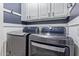 Modern laundry room with LG washer and dryer and white cabinets at 5239 Rayanna Ct, Phoenix, AZ 85015