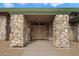 Elegant entryway with double doors and stone pillars at 5540 E Shea Blvd, Scottsdale, AZ 85254