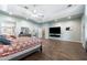 Main bedroom with hardwood floors and a large TV at 5540 E Shea Blvd, Scottsdale, AZ 85254