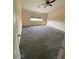 Carpeted bedroom with neutral walls, ceiling fan, and a window at 6102 S 37Th Ln, Phoenix, AZ 85041