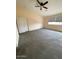 Spacious bedroom with gray carpet, ceiling fan, and a window at 6102 S 37Th Ln, Phoenix, AZ 85041