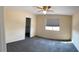 Bedroom with a ceiling fan, carpet, and a large window at 6102 S 37Th Ln, Phoenix, AZ 85041