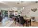 Bright dining area with wood table and view into the living room at 6233 W Maya Dr, Phoenix, AZ 85083