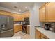 Modern kitchen with wood cabinets and stainless steel appliances at 6233 W Maya Dr, Phoenix, AZ 85083