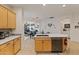 Kitchen with island, wood cabinets, and stainless steel appliances at 6233 W Maya Dr, Phoenix, AZ 85083