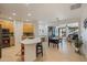 Open concept kitchen with island and view into living room at 6233 W Maya Dr, Phoenix, AZ 85083