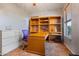 Bright home office with wood desk and built-in shelving at 6233 W Maya Dr, Phoenix, AZ 85083