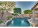 Inviting backyard pool with waterfall feature at 6233 W Maya Dr, Phoenix, AZ 85083