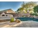 Inviting backyard oasis with a sparkling pool and built-in fire pit at 6233 W Maya Dr, Phoenix, AZ 85083