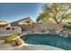 Inviting backyard oasis with a pool, waterfall, and fire pit at 6233 W Maya Dr, Phoenix, AZ 85083