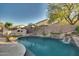 Large pool with a stone fire pit and waterfall at 6233 W Maya Dr, Phoenix, AZ 85083