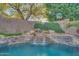 Serene waterfall feature next to the pool at 6233 W Maya Dr, Phoenix, AZ 85083