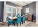 Elegant dining room features a rustic sideboard and teal velvet dining chairs at 6251 E Bramble Berry Ln, Cave Creek, AZ 85331