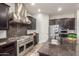 Modern kitchen with stainless steel appliances, large island, and granite countertops at 6251 E Bramble Berry Ln, Cave Creek, AZ 85331