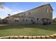 Spacious backyard featuring a well-maintained lawn, a covered patio area, and a view of the two-story home at 638 W Nido Ave, Mesa, AZ 85210