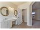 Inviting bathroom with dual sinks, mirrors, and an adjoining space with natural light at 638 W Nido Ave, Mesa, AZ 85210