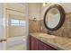 Bathroom featuring an oval mirror, decorative tile backsplash, and view of the bathtub at 638 W Nido Ave, Mesa, AZ 85210