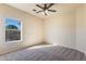 Serene bedroom showcasing a ceiling fan and a window with views of the yard at 638 W Nido Ave, Mesa, AZ 85210