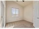 A light and airy bedroom with neutral carpet, a bright window, and door to the outside at 638 W Nido Ave, Mesa, AZ 85210