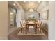 Elegant dining room with a chandelier, light walls, and a dining table set for a gathering at 638 W Nido Ave, Mesa, AZ 85210