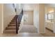 Welcoming entryway with carpeted stairs, adjacent bathroom, and neutral color palette at 638 W Nido Ave, Mesa, AZ 85210