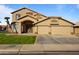 Charming tan two-story home with manicured front lawn, a spacious three car garage, and an arched front porch at 638 W Nido Ave, Mesa, AZ 85210