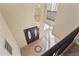 A view of the foyer from above, showcasing an elegant chandelier, tile design, and front doors at 638 W Nido Ave, Mesa, AZ 85210