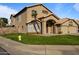 Charming two-story home featuring an arched entryway and well-maintained lawn at 638 W Nido Ave, Mesa, AZ 85210