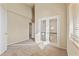 Hallway featuring neutral carpet and a view of the chandelier and open floor plan through french doors at 638 W Nido Ave, Mesa, AZ 85210